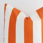 Very close photo of orange striped cushion. The shot shows the outdoor material and large dimensions with more clarity.