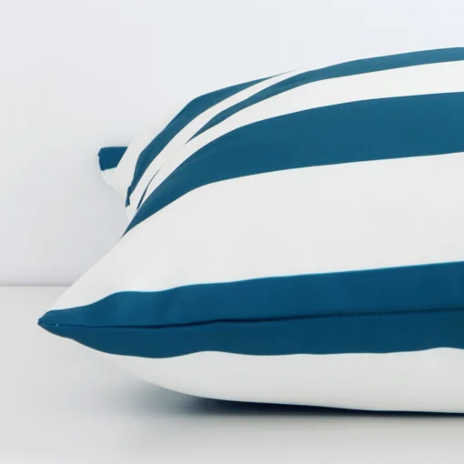 A side view of teal striped cushion that has outdoor fabric and a large size.