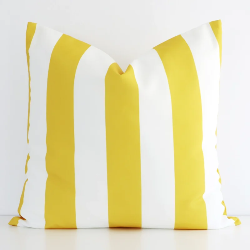 otama-striped-waterproof-yellow-large-outdoor-cushion-cover---large---sc729-55 Yellow striped cushion cover in front of a white wall. It has a large size and is made from an outdoor material.