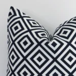 Focused view of geometric square cushion cover. The shot shows details of its outdoor material and black-and-white colour.