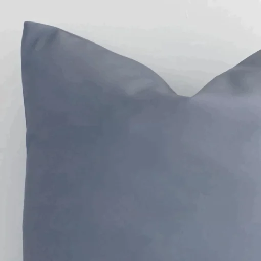Macro shot showing the top left side of this square outdoor cushion. The grey hue and solid colour design are magnified.