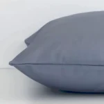 Lateral viewpoint of this outdoor square cushion. The solid grey colour design is shown from the side showing the front and rear panels.