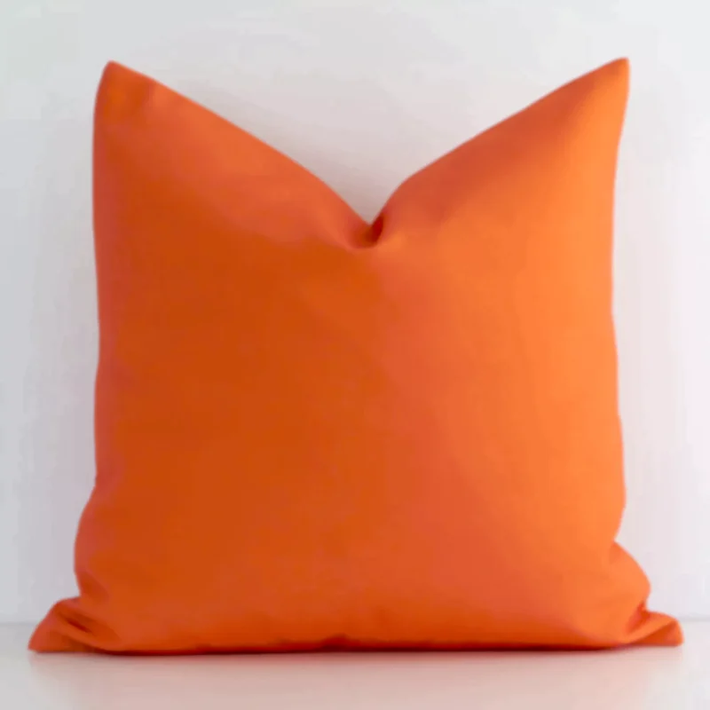 otama-waterproof-orange-outdoor-cushion-cover---sc714-45 Square outdoor cushion cover in orange colour sitting upright in front of a white wall. It has been made from a quality outdoor material.