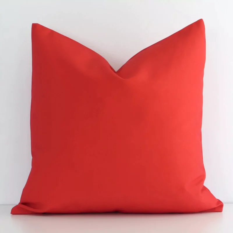 otama-waterproof-red-outdoor-cushion-cover---sc718-45 Outdoor cushion with a solid colour design in an upright position against a white wall. It is red in colour.