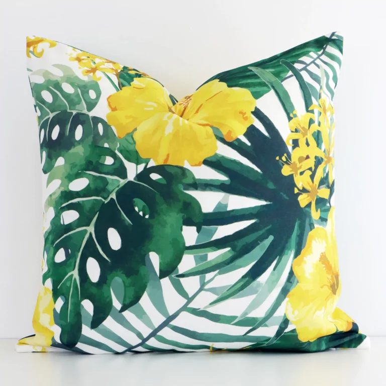 A graceful square yellow cushion with a floral style on durable outdoor fabric.