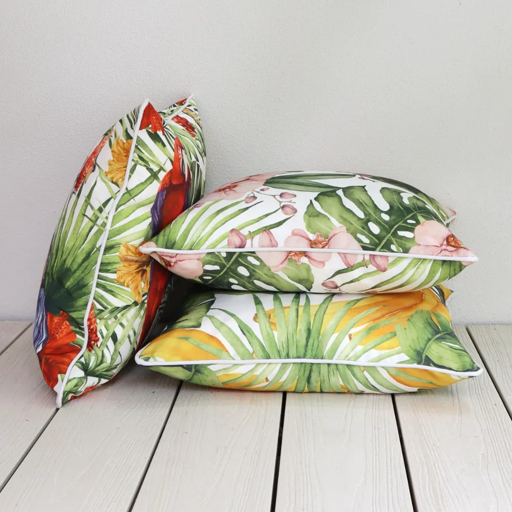 An outside wall with tropical outdoor cushions laying against it.