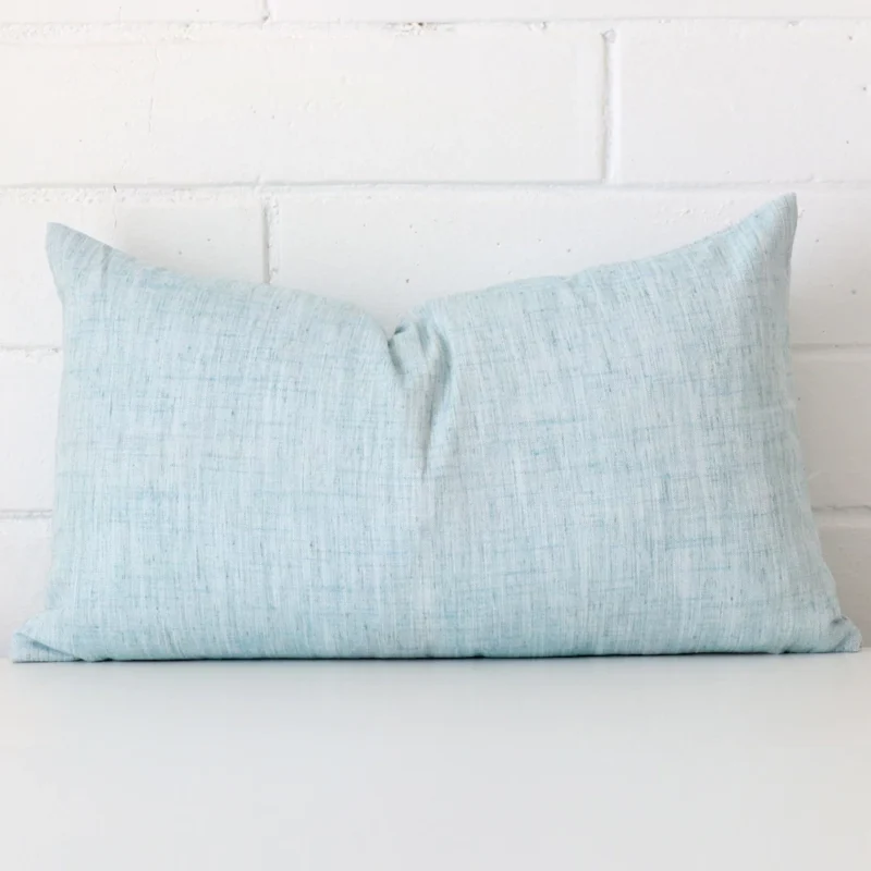 panama-duck-egg-rectangular-cushion-cover-30x50-sc800-30 A pretty linen cushion cover is shown against a brick wall. It features a rectangle shape and a duck egg colour finish.