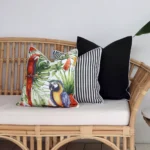 An outdoor setting that has three black outdoor couch cushions styled on it.