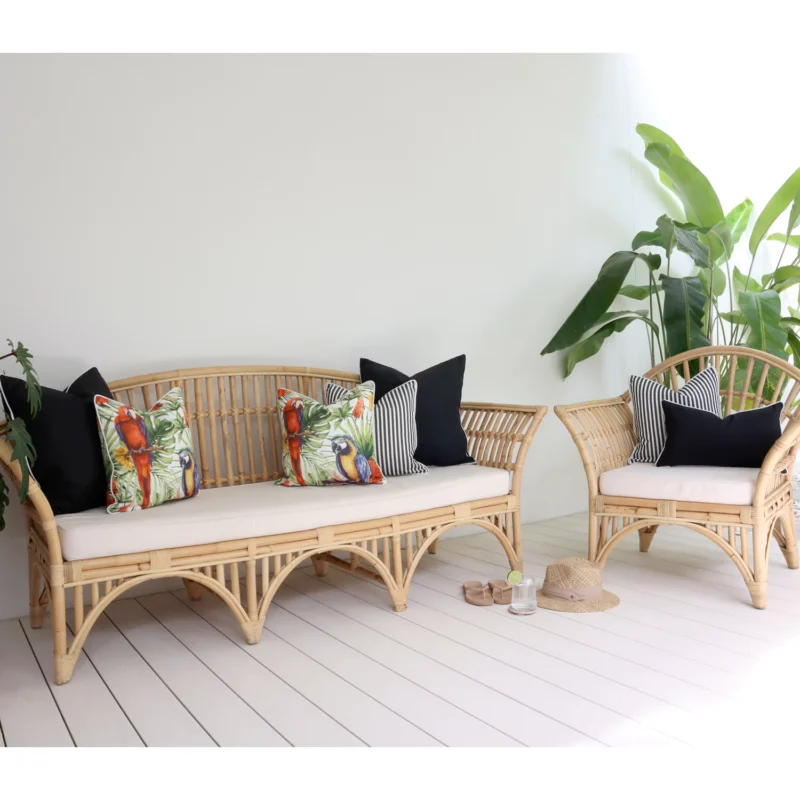 parrots-black-outdoor-lounge-cushions-set-7-covers-colo1182 Some lovely black and parrot-printed outdoor cushions are arranged neatly on a rattan seat adding a fun and stylish vibe to the outdoor area.