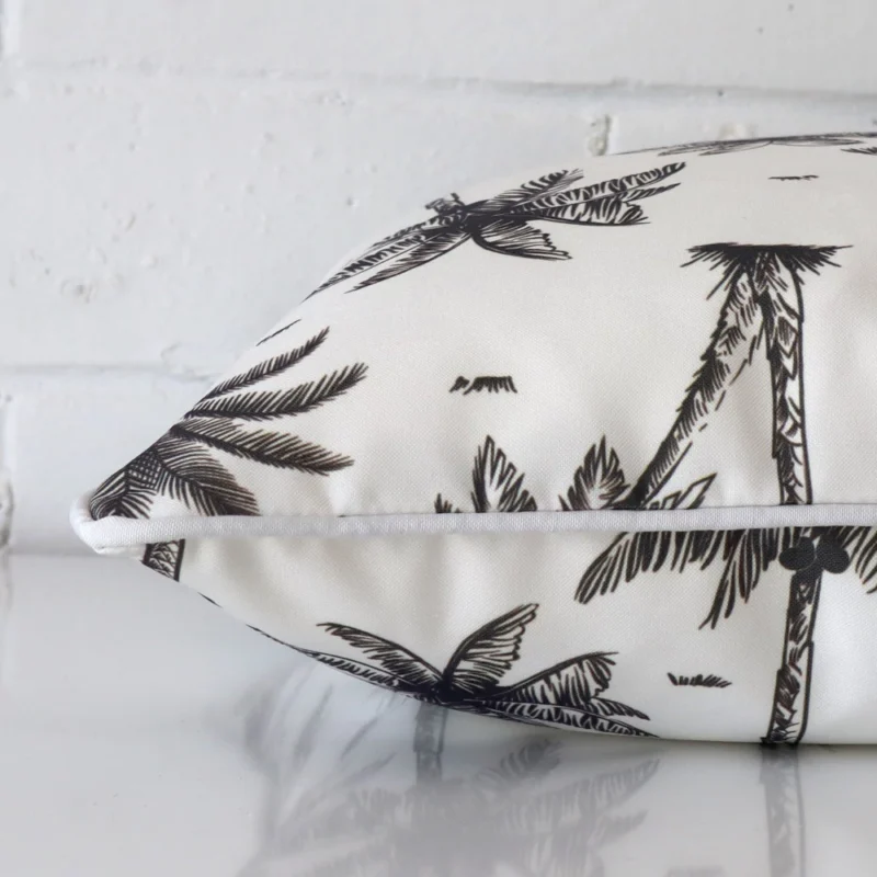 A side shot of an outdoor cushion cover. The angle shows the edge of the square shape and the black and white tone.