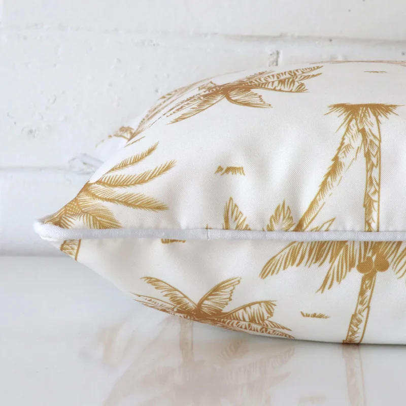 A square outdoor cushion positioned flat to show its seams. The mustard colour and design are visible as is the seam between the panels