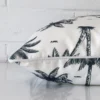 An outdoor navy blue cushion cover shown laying on its side. The design and its square shape are shown side on.