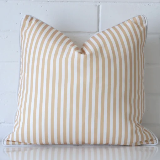 A hero shot of a square cushion cover. It is made from a deluxe outdoor fabric and features a beige colour.