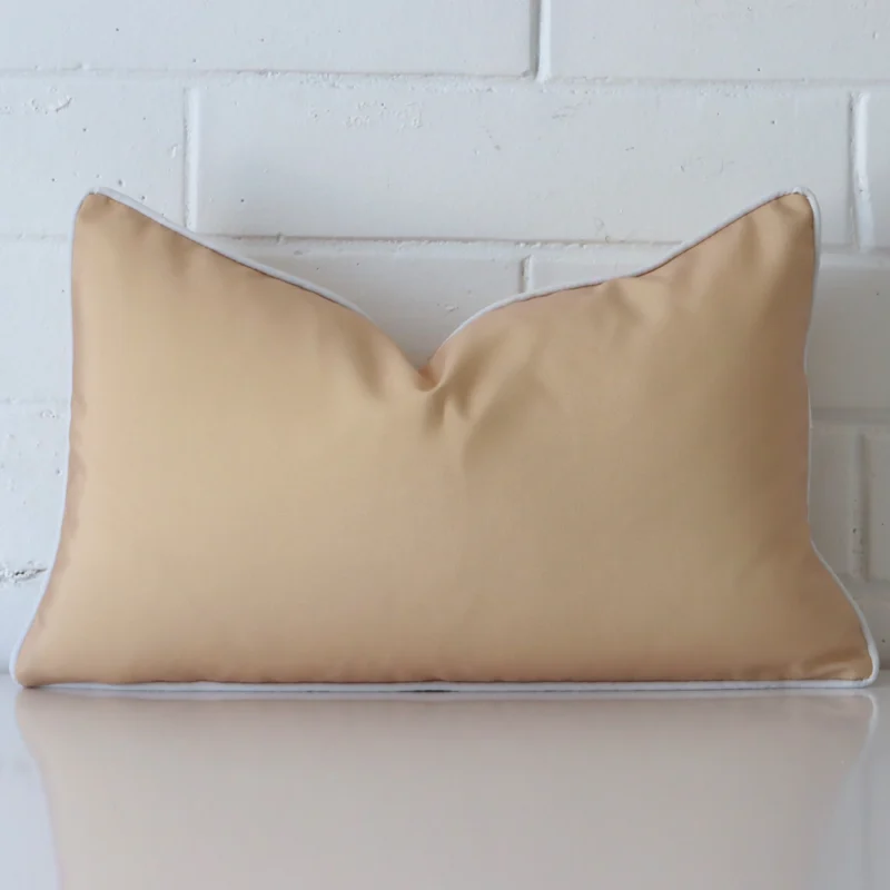 piha-waterproof-beige-outdoor-cushion-cover-rectangle-sc915-30 A brick wall that has a beige cushion cover positioned in front of it. It has an exquisite outdoor material and a lovely rectangle shape.