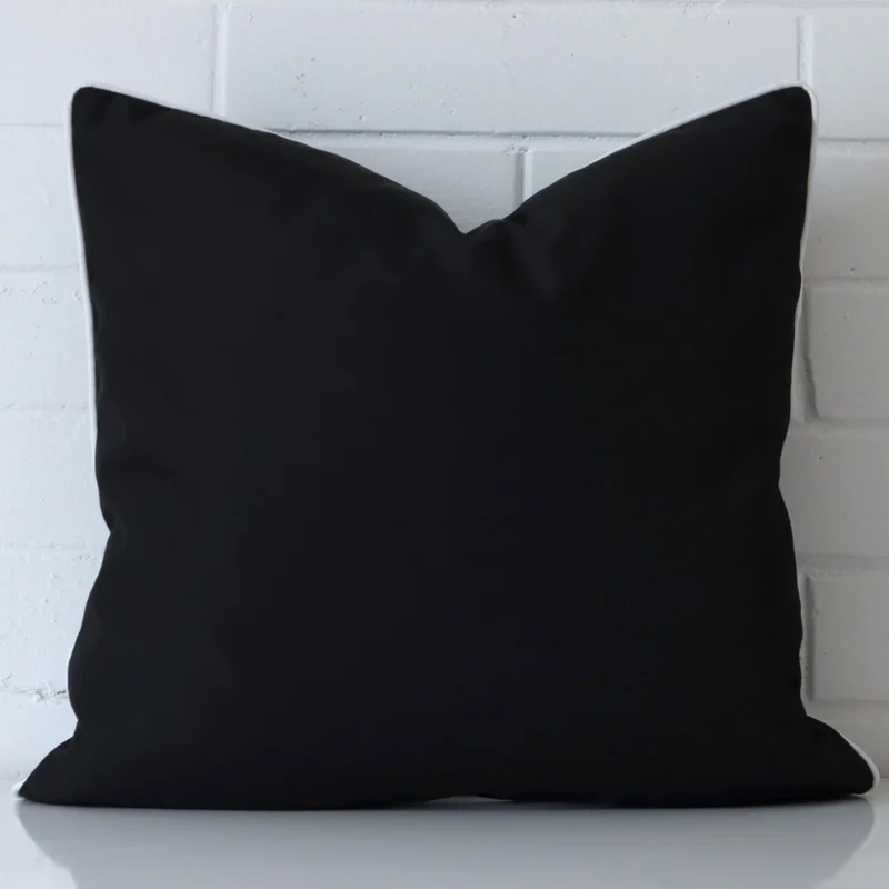 piha-waterproof-black-outdoor-cushion-cover-rectangle-sc903-55 An outdoor large cushion cover that is shown vertically against a brick wall. It has a wonderful black colour.
