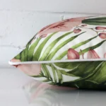 Side angle of a floral cushion cover that has outdoor fabric and a square size.