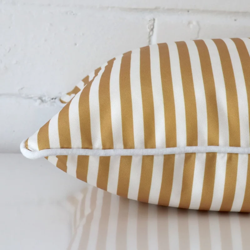 The seams of this outdoor square cushion cover in mustard are shown.