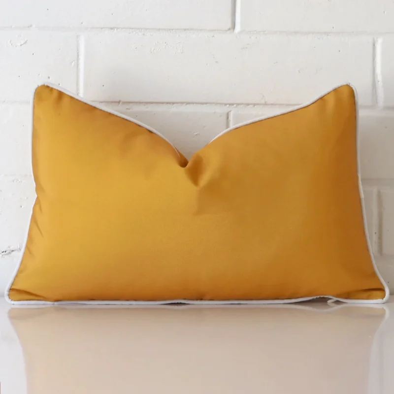piha-waterproof-mustard-outdoor-cushion-cover-rectangle-sc900-30 Mustard cushion leans elegantly against a brick wall. It has been crafted from a high quality outdoor material and has a rectangle shape.