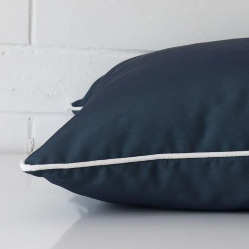A large outdoor cushion positioned flat to show its seams. The navy blue colour is shown up close.
