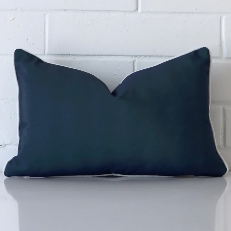 piha-waterproof-navy-blue-outdoor-cushion-cover-rectangle-sc909-30 A pretty outdoor cushion cover is shown against a brick wall. It features a rectangle shape and a navy blue colour finish.