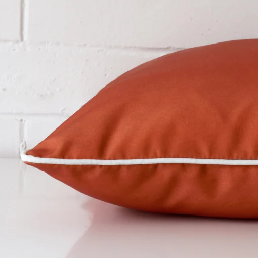 Side image of an outdoor large cushion cover. The terracotta colour is more visible from the side showing the attachment of the panels.