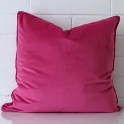 An eye-catching velvet large cushion cover featuring a pink hue.
