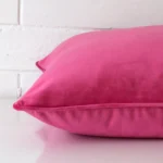 A bold velvet cushion in a sleek large size with a pink tone of colour.