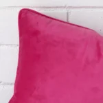 Macro image of a velvet rectangle cushion cover. The shot shows the pink hue more thoroughly.