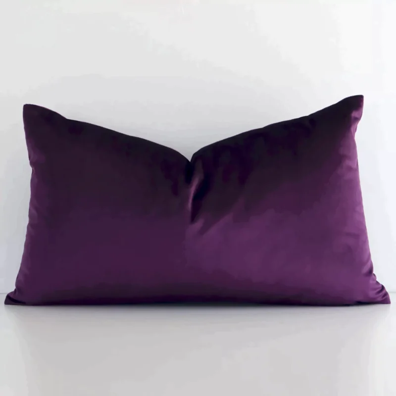 plum-purple-velvet-linen-rectangular-cushion-cover---rectangle---sc788-30 Ractangular solid-coloured cushion cover in plum purple colour sitting upright in front of a white wall. It has been made from a quality velvet material.