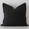 A hero shot of a large cushion cover. It is made from a deluxe linen fabric and features a black colour.