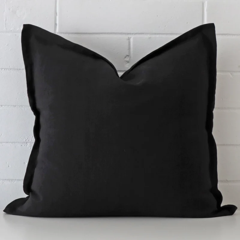 pure-black-linen-cushion-cover-sc814-55 A hero shot of a large cushion cover. It is made from a deluxe linen fabric and features a black colour.