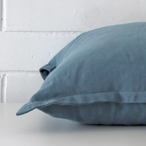 Side angle of blue cushion cover that has linen fabric and a large size.