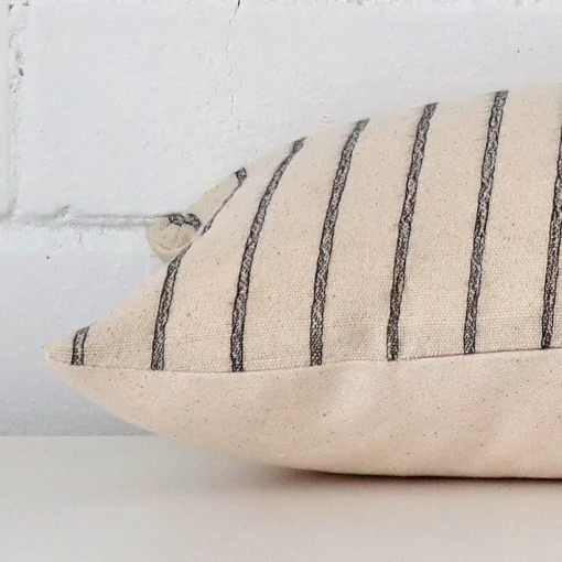 A striped cushion arranged sideways in front of a wall. The rectangle size and designer fabric are shown and the seams are clearly visible.
