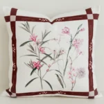Burgundy bordered cushion cover with pink botanical centre print.
