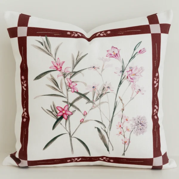 Burgundy bordered cushion cover with pink botanical centre print.
