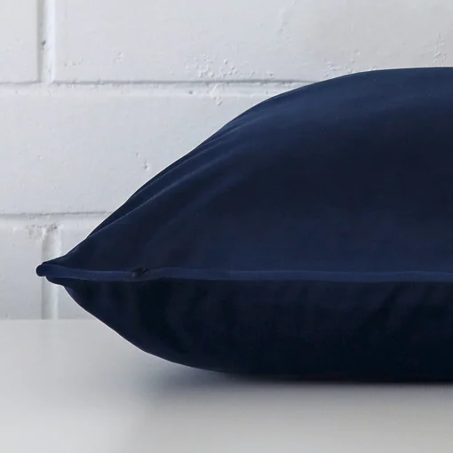 Side shot showing the seam of this large royal blue cushion that features a velvet material.