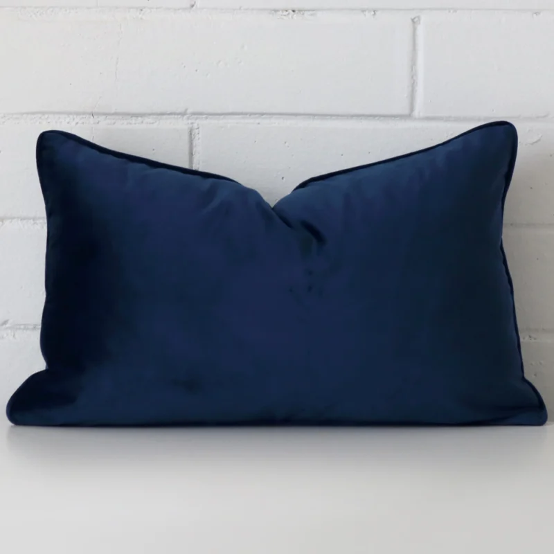 royal-blue-velvet-rectangular-cushion-cover-30cm-x-50cm-sc774-30 A brick wall that has a royal blue cushion cover positioned in front of it. It has an exquisite velvet material and a lovely rectangle shape.