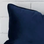 Zoomed photo of the top left corner of this royal blue cushion cover. The image clearly shows the velvet material and ractangle dimensions.