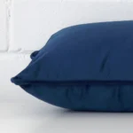 Side image of a linen rectangle cushion cover. The royal blue colour is shown up close.