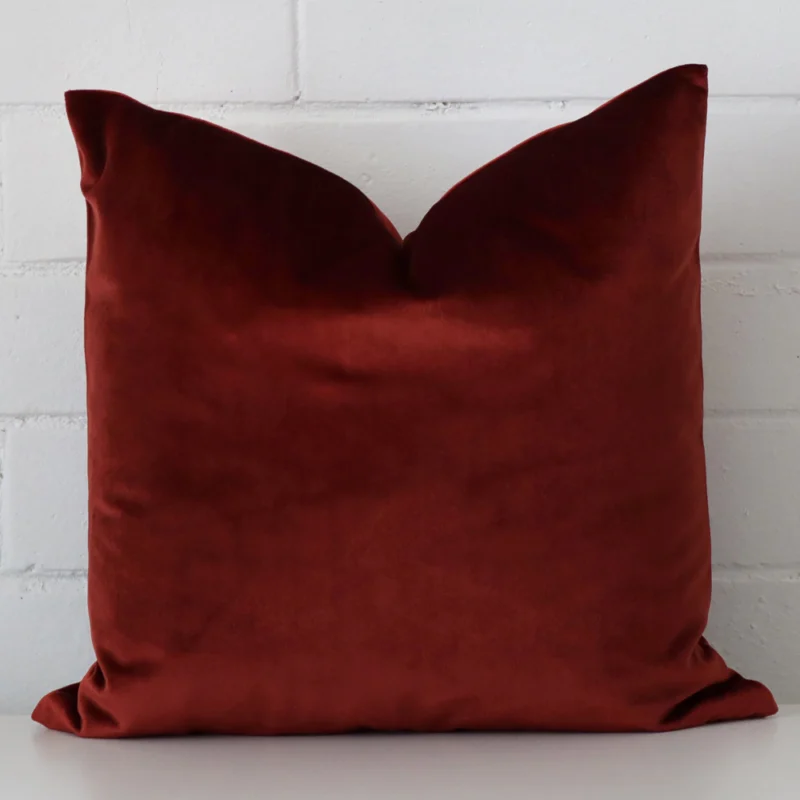 rust-velvet-cushion-cover-sc1051-45b A hero shot of a square cushion cover. It is made from a deluxe velvet fabric and features a rust colour.