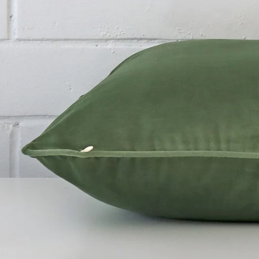 Lateral angle image of a velvet large cushion. The sage colour is highlighted.
