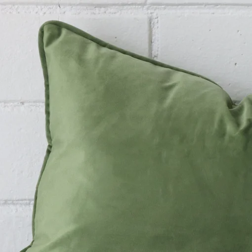 Close up image of top corner of this sage cushion. This shows the velvet fabric and rectangle shape up close.