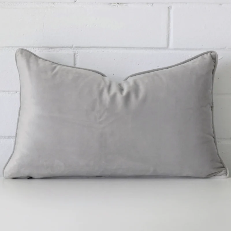 silver-grey-rectangular-velvet-cushion-cover-30cm-x-50cm-sc495-30b A pretty velvet cushion cover is shown against a brick wall. It features a rectangle shape and a silver grey colour finish.
