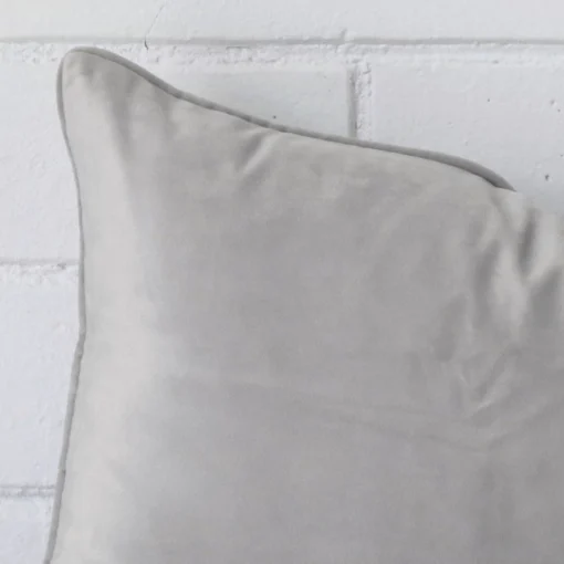 Close up image of top corner of this silver grey cushion. This shows the velvet fabric and rectangle shape up close.
