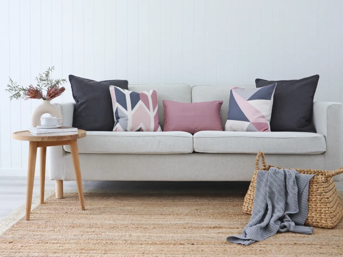 A sofa arrangement featuring Scandi style cushions in pink colours.