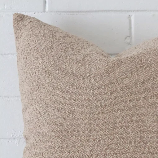 A boucle large cushion’s corner has been enlarged in this shot. The beige colour is shown up close.