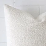Enlarged shot of a large white cushion cover that is made from a boucle fabric.
