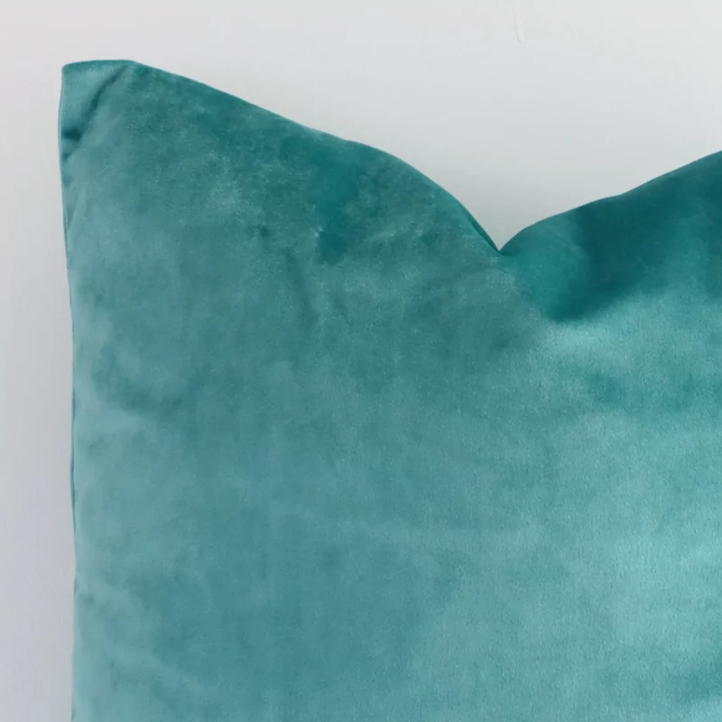 Macro image of a velvet square cushion cover. The shot shows the spearmint hue and solid colour style more thoroughly.