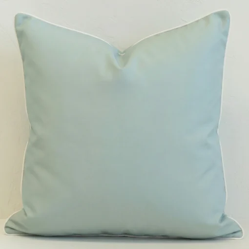 Stonebay seafoam outdoor cushion in plain light blue with white piping.