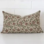A pretty floral designer cushion cover is shown against a brick wall. It features a rectangle shape.